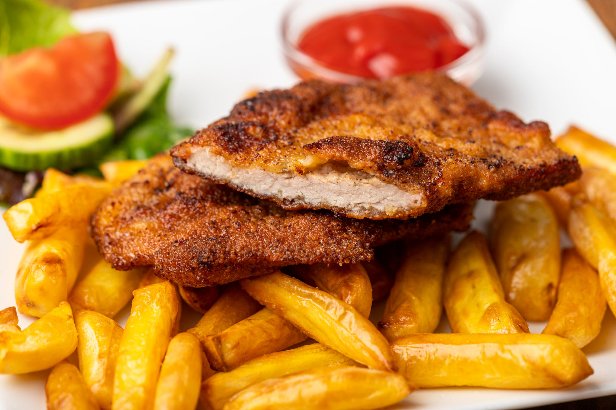 wiener schnitzel with french fries on a plate
